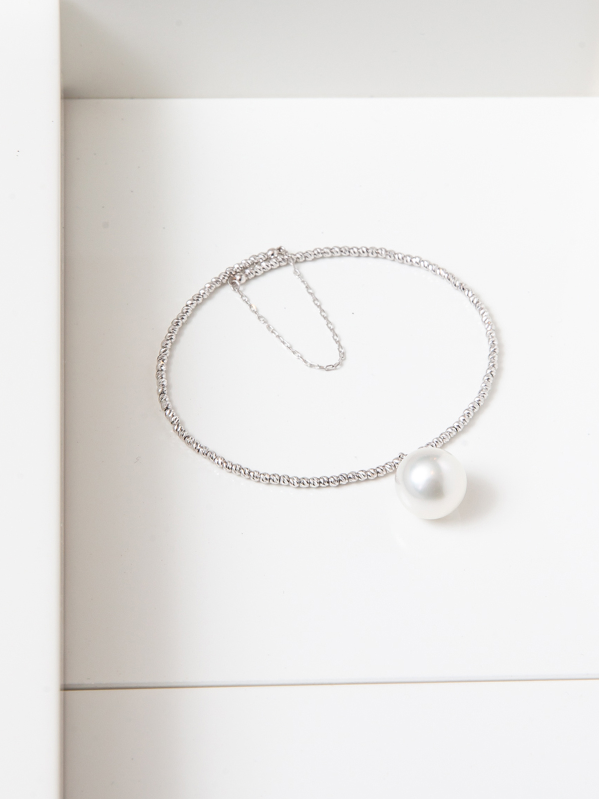 Beautiful bangle with single pendant pearl and fine gold chain