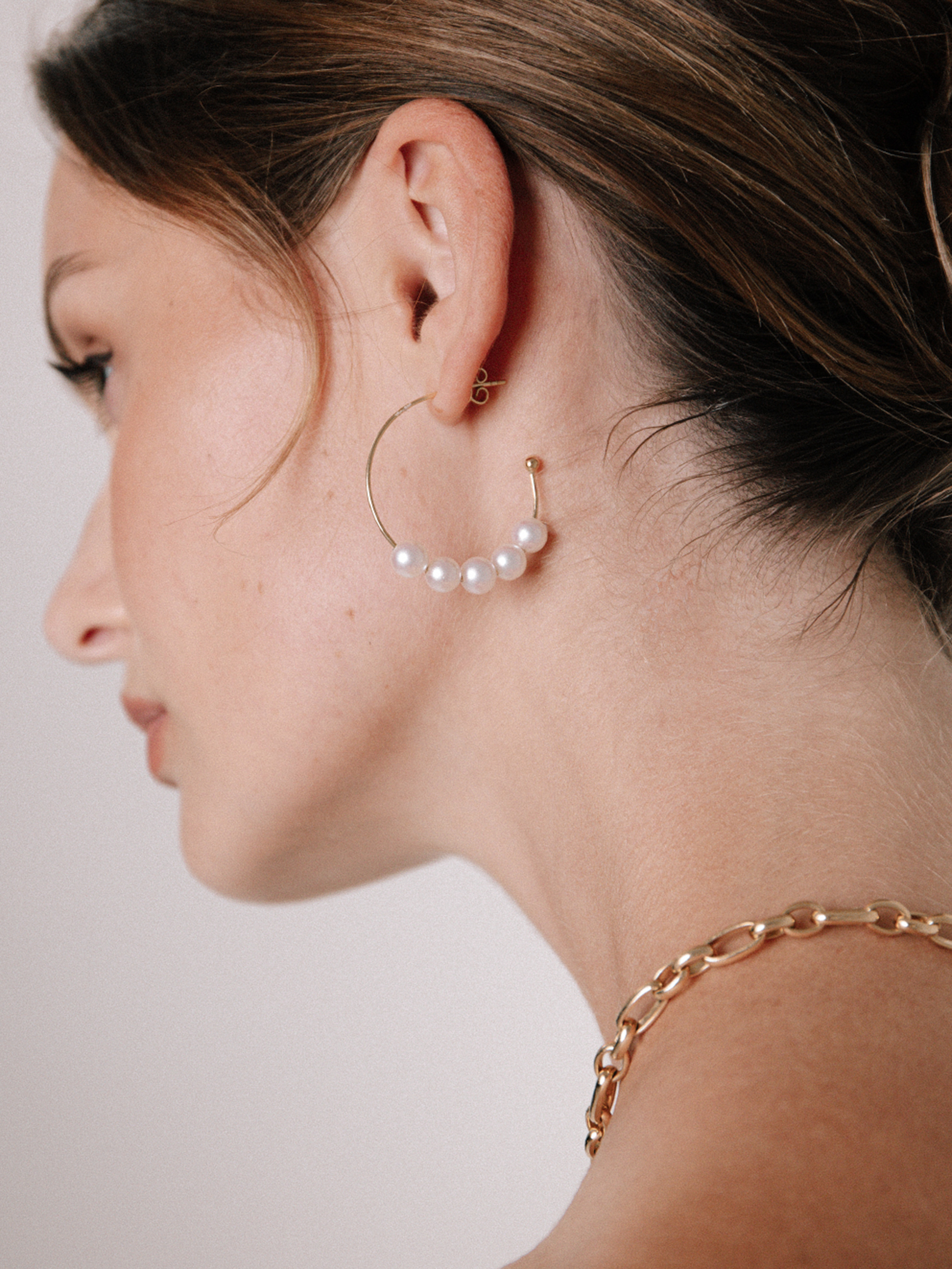 Delicate yellow gold hoops with white pearls